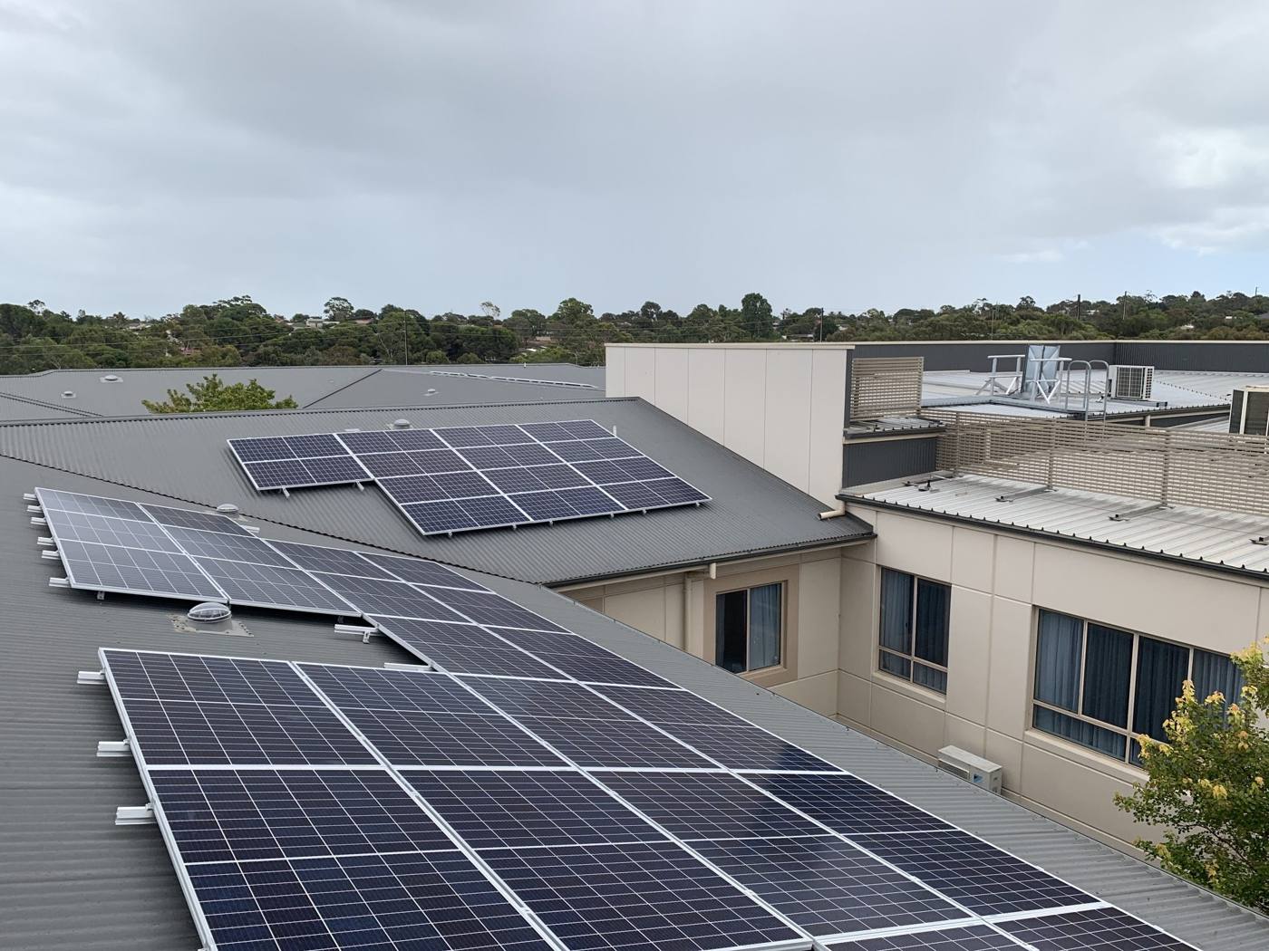 Solar arrays across the roofs of a multi-storey commercial building